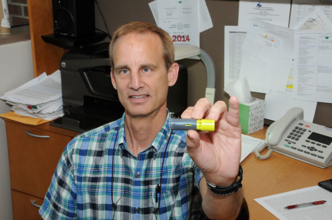 Dr. S. Casey Laizure holds an Aeroshot™ 100 mg caffeine administration device, an integral part of his NIH-funded study, sold by Breathable Foods, Inc. The study of this device, which dispenses caffeine upon inspiration, will provide insight into caffeine blood levels achieved after inhalation.