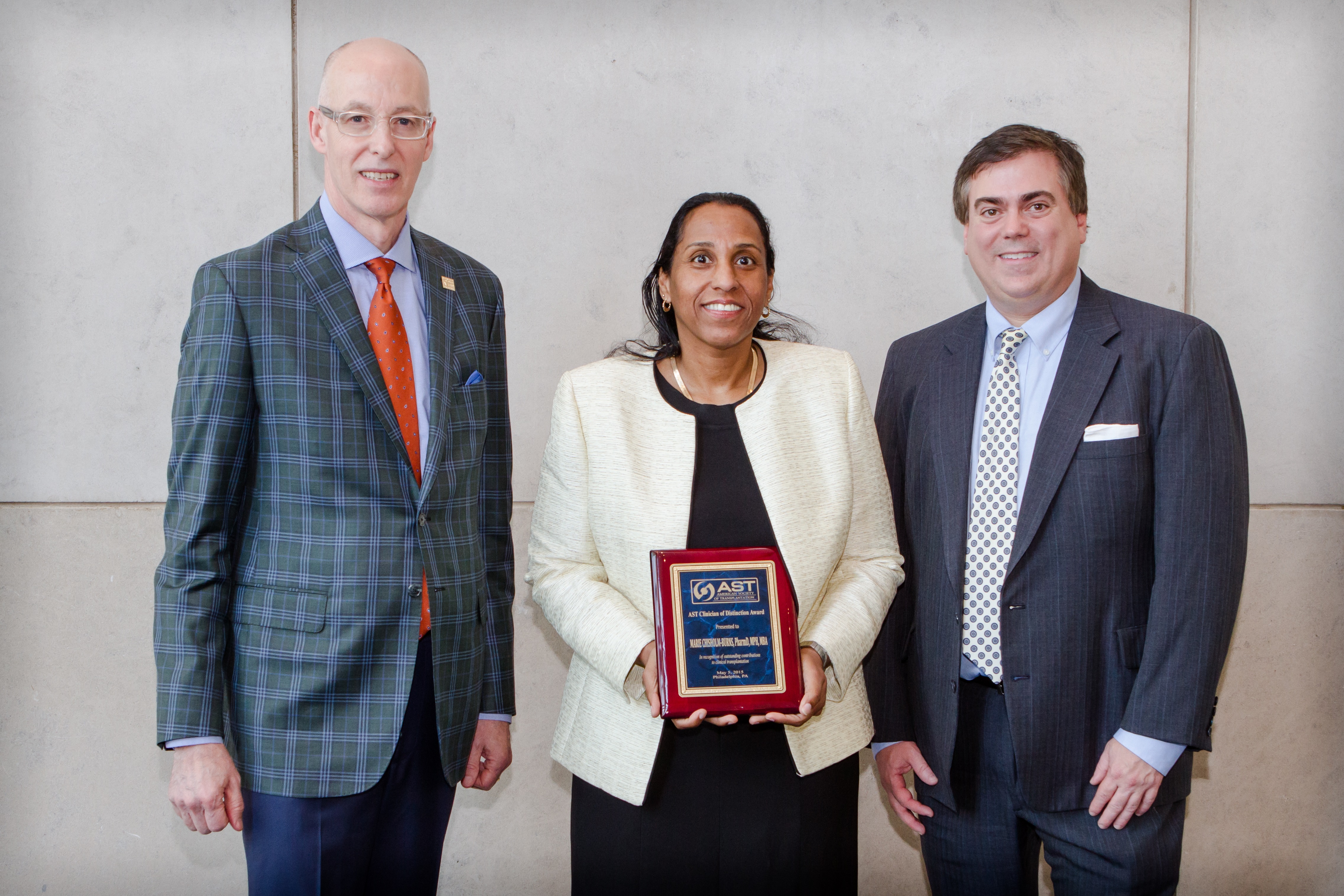 Dr. Marie Chisholm-Burns, dean of the College of Pharmacy at UTHSC, center, received the Clinician of Distinction Award from the American Society of Transplantation (AST). With her are Kenneth Newell, AST immediate past president, and James Allan, AST president.