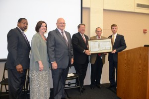 Chancellor Steve Schwab, MD, second from right, receives a certificate designating UTHSC as a "VETS Campus" from Sen. Mark Norris, to his left, and Russ Deaton, interim THEC executive director, far right. They are joined by Dr. Ken Brown, UTHSC executive vice chancellor and COO, far left, Dr. Lori Gonzalez, vice chancellor for Academic, Faculty and Student Affairs at UTHSC, and John Drnek, assistant commissioner of the Tennessee Department of Veterans Services.