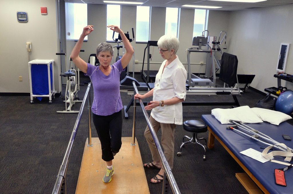 Ann Coleman works with D. McLendon in the bright new University Therapists location on campus.