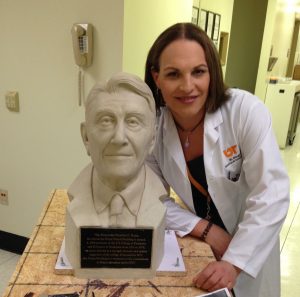 Maddie Singer blends art and science in her work. She is shown with a bust of former Gov. Winfield C. Dunn that she created.