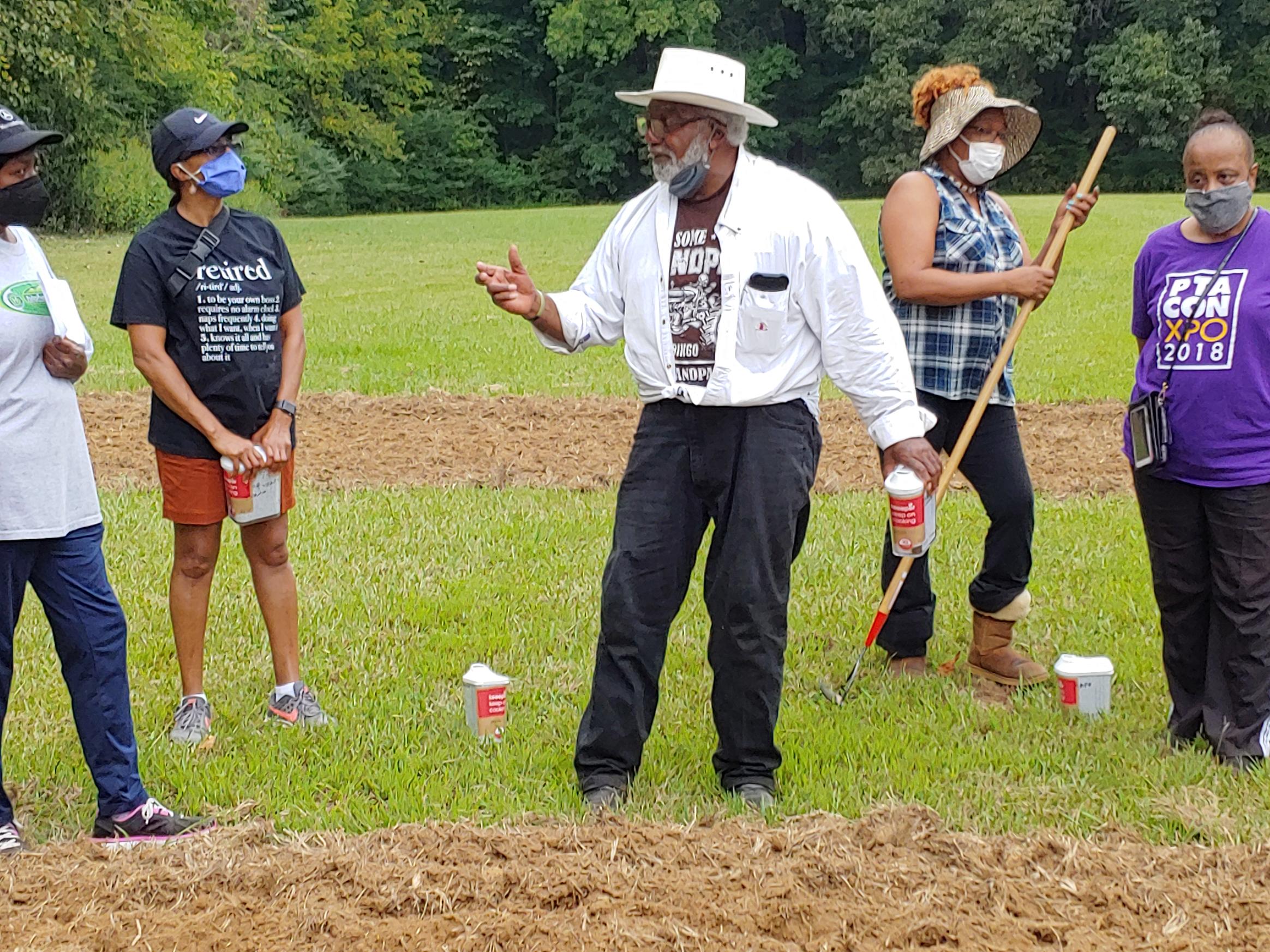 Urban gardening volunteer Ernest Trice explains planting to area residents in the new Frayser Community Garden.