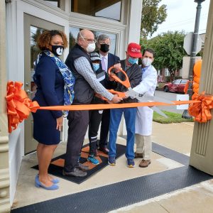 Cutting the ribbon to open the UTHSC Health Hub at Uptown Saturday were Michelle Taylor, MD, director of the Shelby County Health Department; Scott Strome, MD, executive dean of the UTHSC College of Medicine, Memphis Mayor Jim Strickland, Henry Turley, member of the UTHSC Coillege of Meidcine Board of Vistiros, and Jim Bailey, MD, who has led the development of the Health HUb.