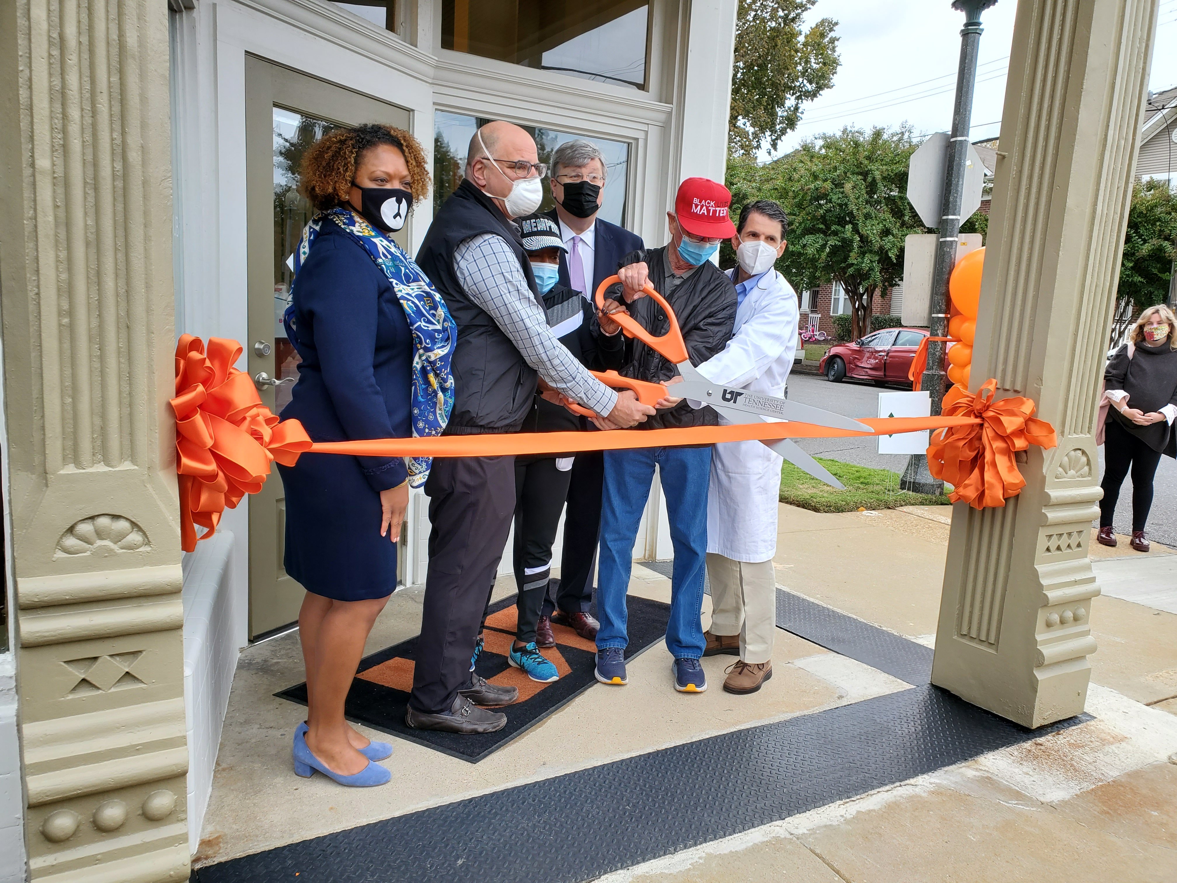 Cutting the ribbon to open the UTHSC Health Hub at Uptown Saturday were Michelle Taylor, MD, director of the Shelby County Health Department; Scott Strome, MD, executive dean of the UTHSC College of Medicine, Memphis Mayor Jim Strickland, Henry Turley, member of the UTHSC Coillege of Meidcine Board of Vistiros, and Jim Bailey, MD, who has led the development of the Health HUb.