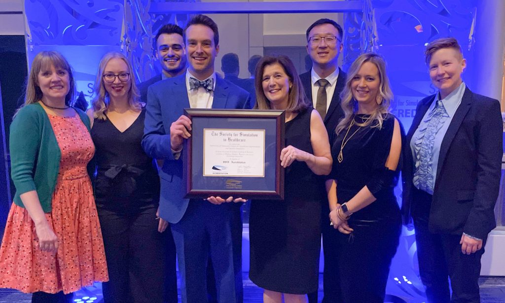 Staff of the Center for Healthcare Improvement and Patient Simulation at UTHSC accept the plaque recognizing the center's accreditation by the Society for Simulation in Healthcare.